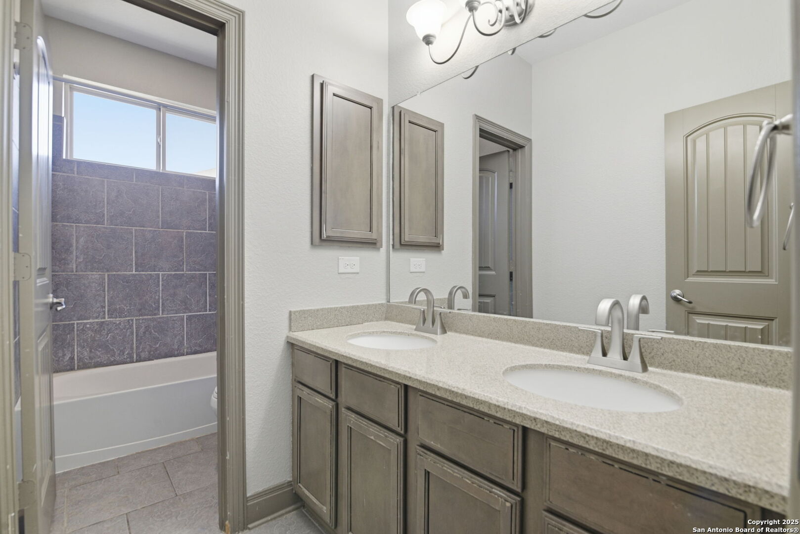 904 Turning Stone Cibolo, TX 78108 - Photo 28 of 35 a bathroom with a granite countertop sink mirror and a bathtub