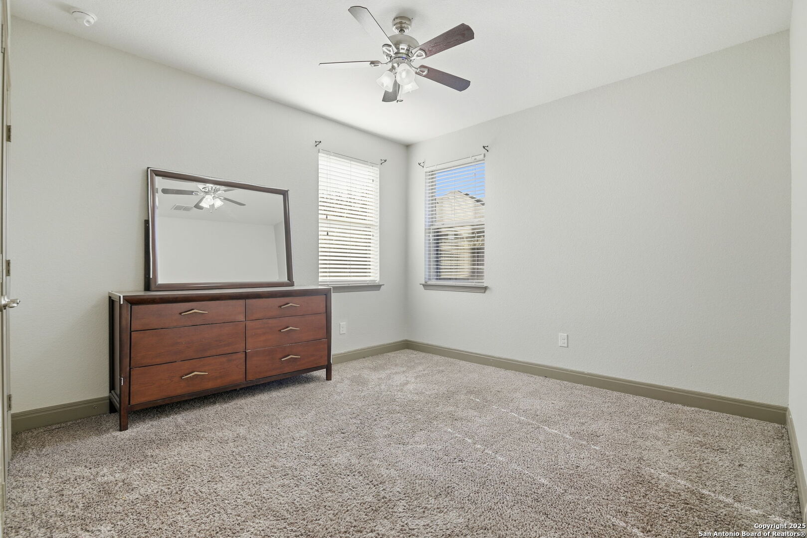 904 Turning Stone Cibolo, TX 78108 - Photo 31 of 35 an empty room with windows and cabinet