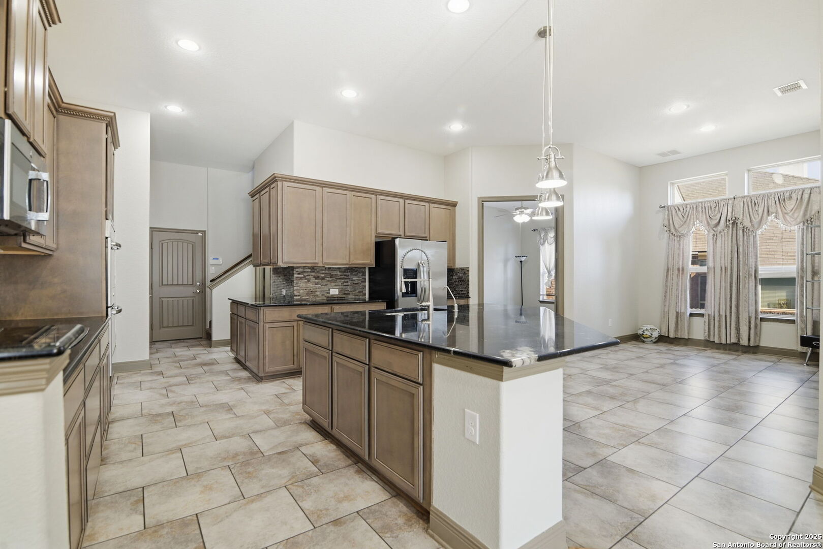 904 Turning Stone Cibolo, TX 78108 - Photo 9 of 35 a kitchen with stainless steel appliances a refrigerator sink and microwave