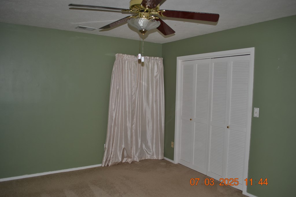 13642 Macon Road Upatoi, GA 31829 - Photo 11 of 34 a view of a room with a chandelier fan and closet