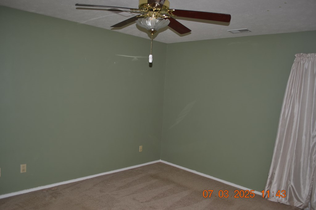 13642 Macon Road Upatoi, GA 31829 - Photo 12 of 34 a view of a small space with wooden floor and fan