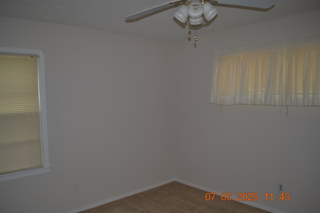 13642 Macon Road Upatoi, GA 31829 - Photo 14 of 34 a small space with a chandelier fan and a window