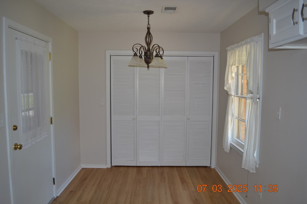 13642 Macon Road Upatoi, GA 31829 - Photo 2 of 34 a view of a room with wooden floor staircase and a ceiling fan