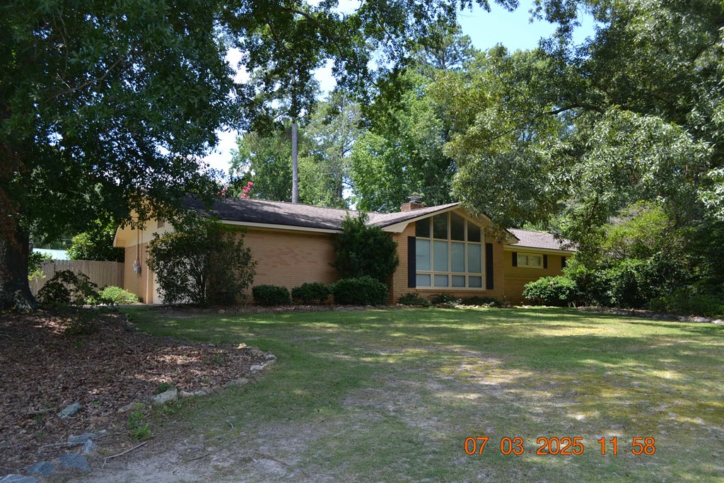13642 Macon Road Upatoi, GA 31829 - Photo 34 of 34 a backyard of a house with large trees and plants