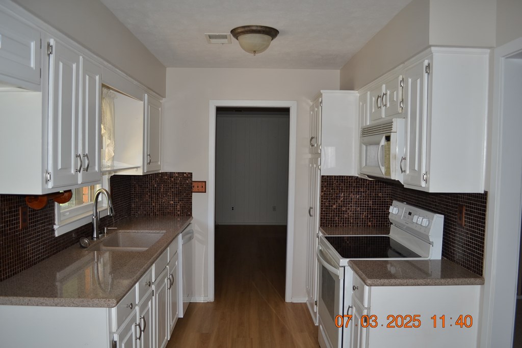13642 Macon Road Upatoi, GA 31829 - Photo 10 of 34 a kitchen with stainless steel appliances granite countertop a sink stove and refrigerator