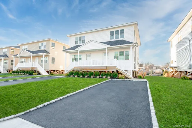 a front view of a house with a garden and yard