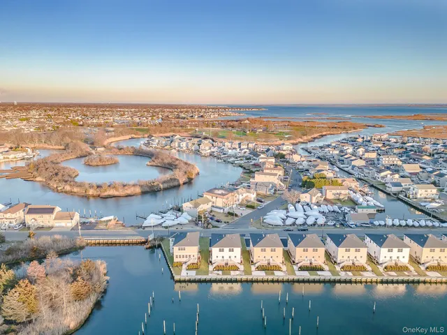 an aerial view of residential building and lake