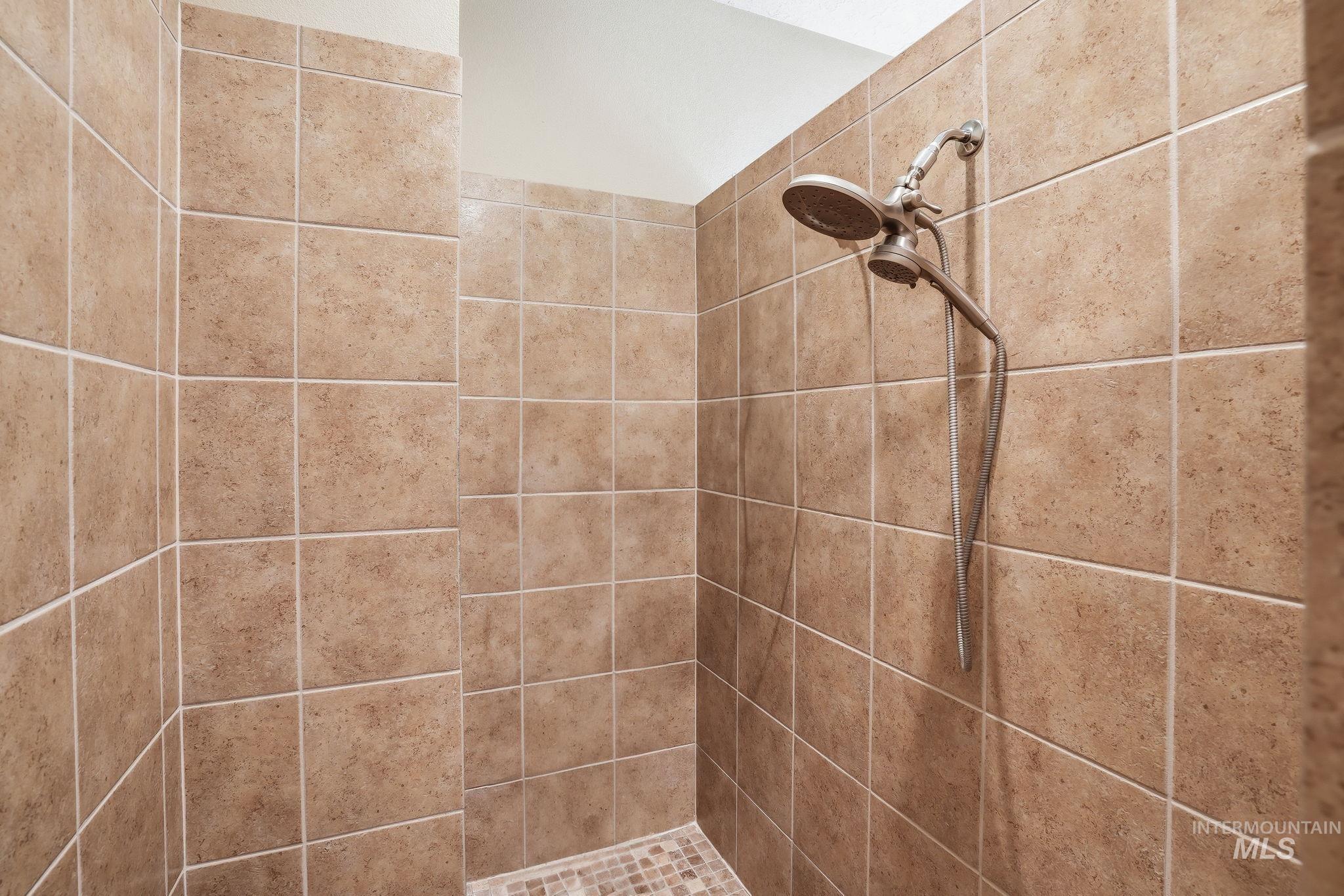 3969 North Hollymount Way Meridian, ID 83646 - Photo 27 of 47 Walk-in shower with full-height beige ceramic tile surround