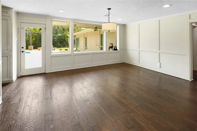 a view of a livingroom with furniture wooden floor and windows