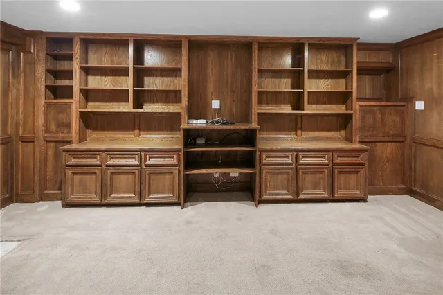 a view of empty room with fireplace and cabinet