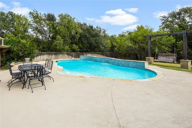 a view of a swimming pool with a patio
