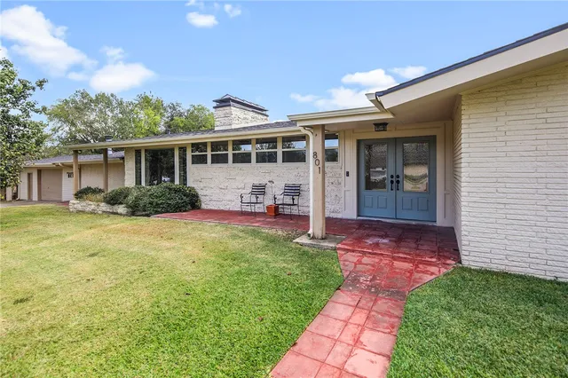 a front view of a house with garden