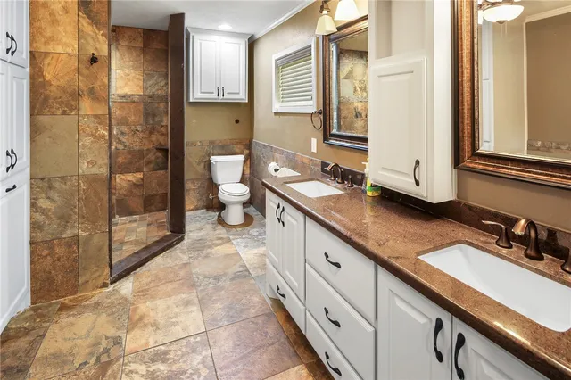 a bathroom with a white tub shower and toilet