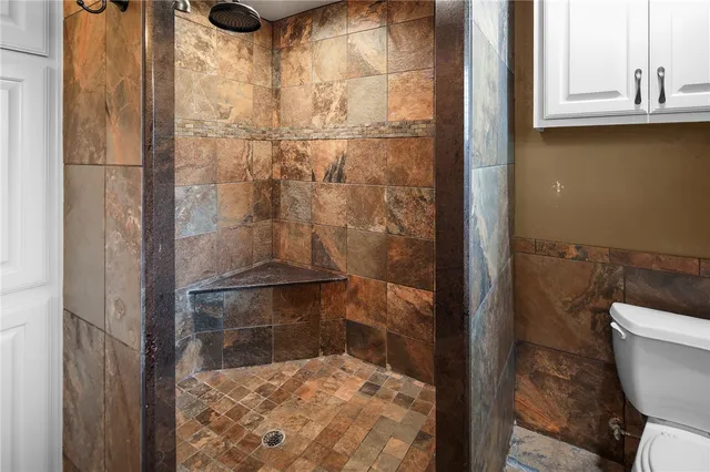 a white bath tub sitting next to a white sink