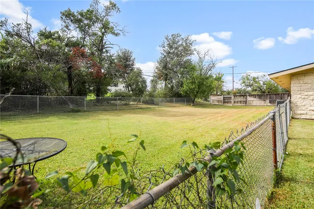 a view of a pool with a yard