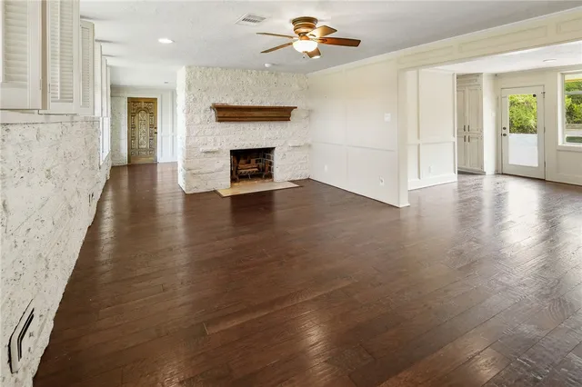 a view of an empty room with window and fireplace