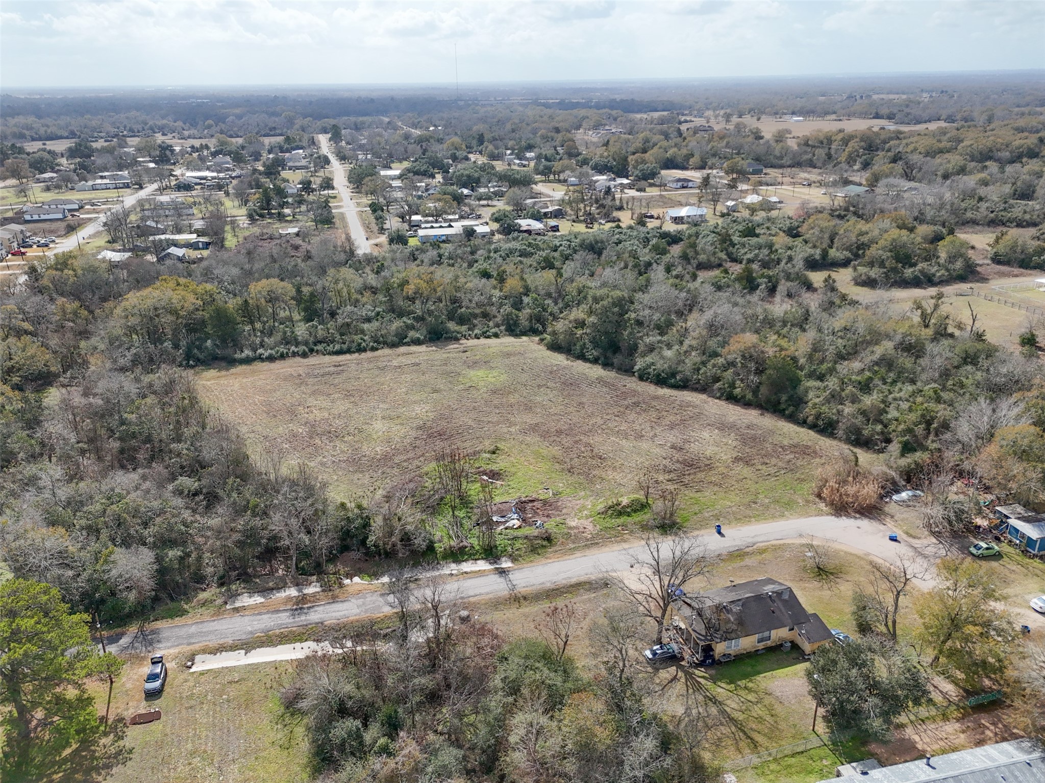 Tbd Tbd 22nd Hempstead, TX 77445 - Photo 8 of 20 Aerial perspective illustrating the property’s position within the surrounding neighborhood, with open land balanced by established greenery.