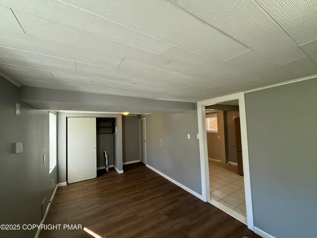 a view of hallway with wooden floor