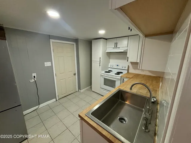 a kitchen with a sink stainless steel appliances and cabinets