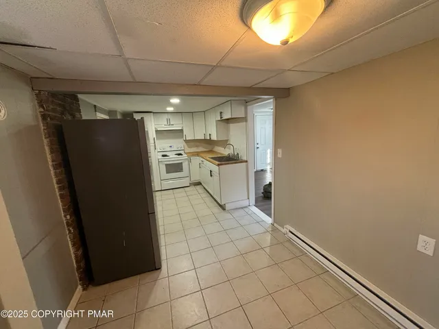 a kitchen with a refrigerator and a stove