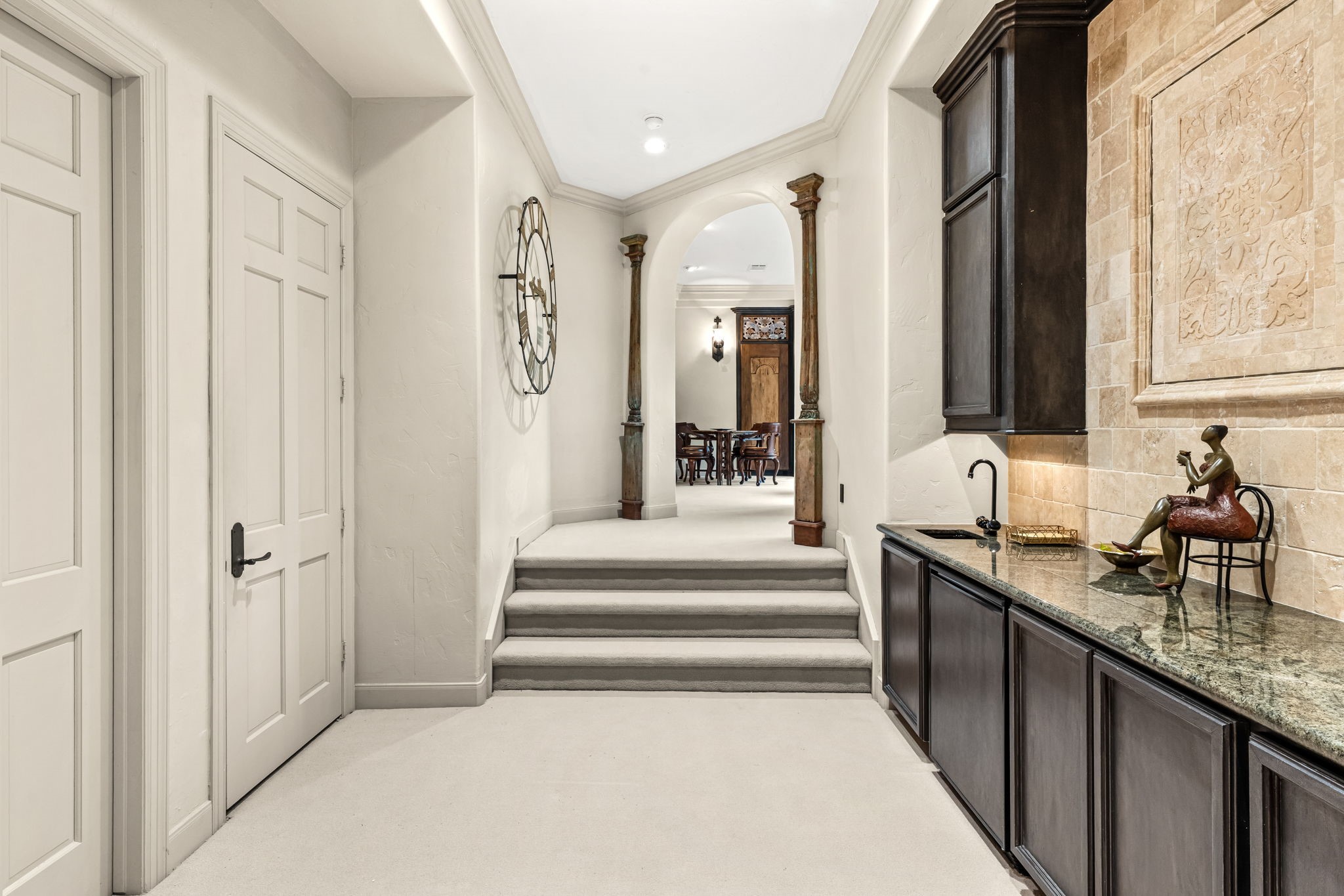 6 Mott Lane Houston, TX 77024 - Photo 35 of 50 Elegant hallway featuring custom built-in cabinetry, beverage fridge and a sink, perfect for a bar or serving area.