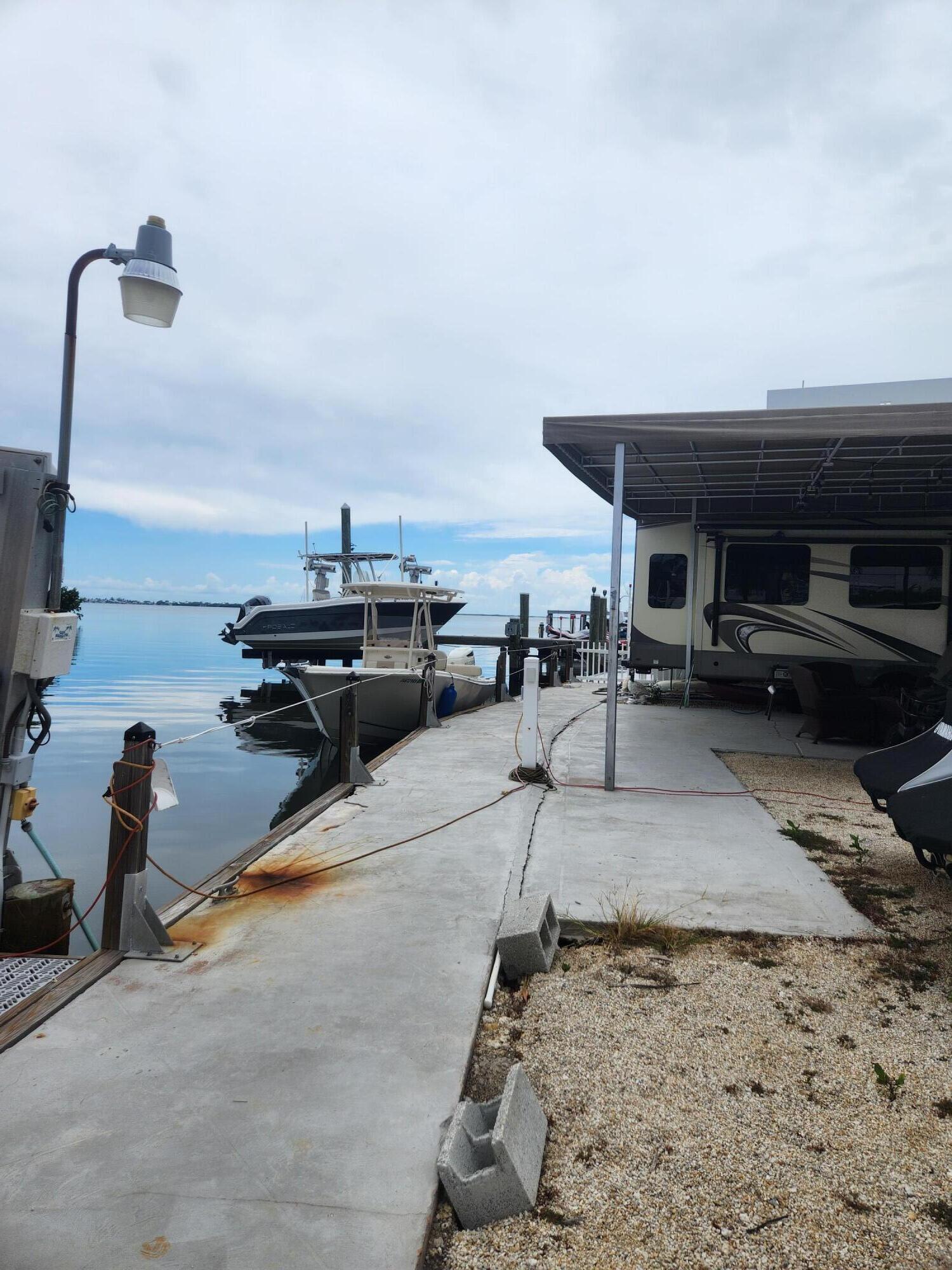 325 Calusa Street, Unit 234 Key Largo, FL 33037 - Photo 14 of 46 a living room with furniture and a flat screen tv