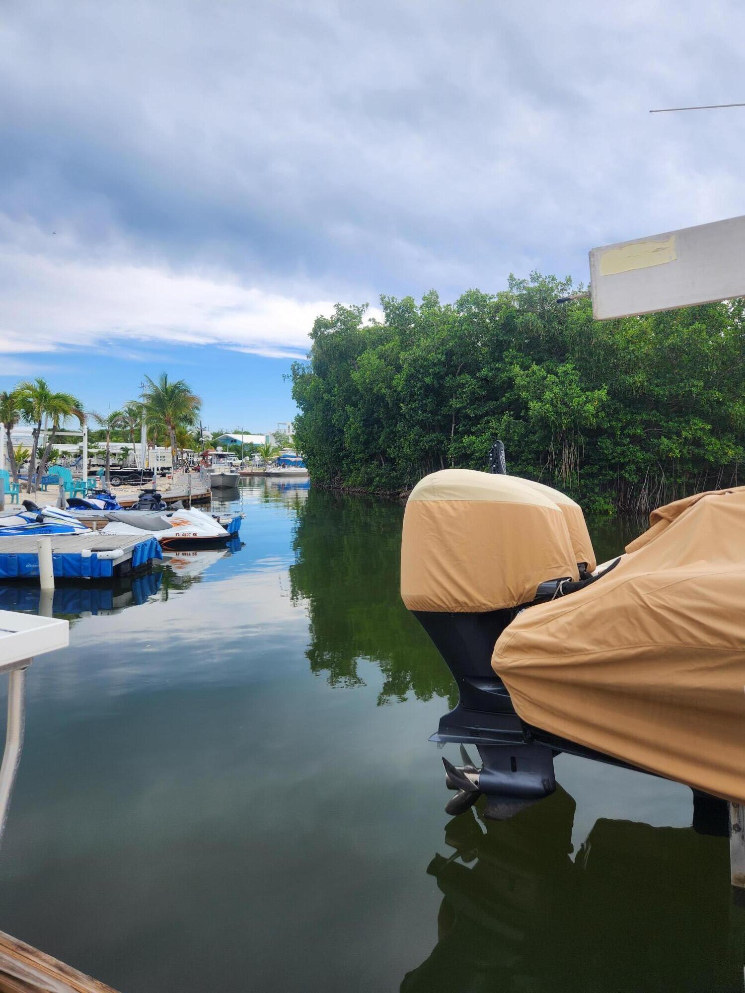 325 Calusa Street, Unit 234 Key Largo, FL 33037 - Photo 17 of 46 a view of a swimming pool and lounge chairs