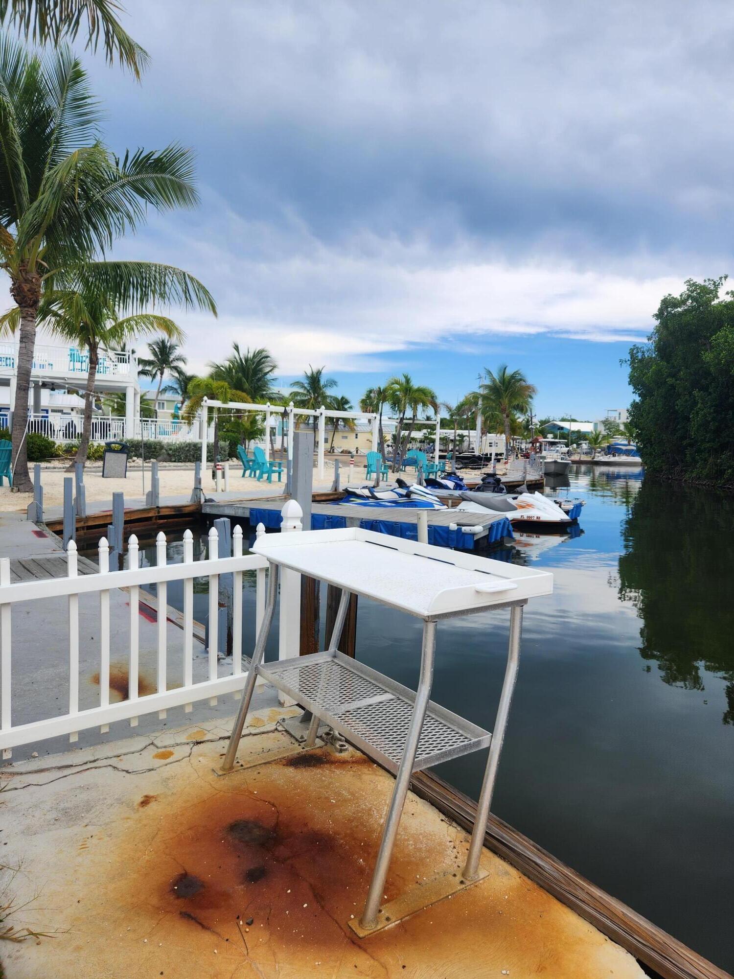 325 Calusa Street, Unit 234 Key Largo, FL 33037 - Photo 20 of 46 a view of swimming pool with outdoor seating and city view