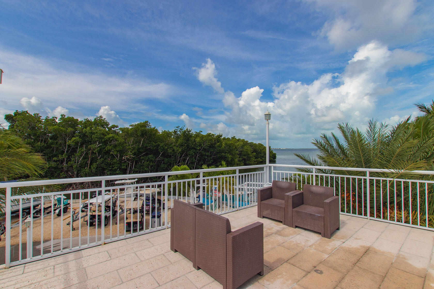 325 Calusa Street, Unit 234 Key Largo, FL 33037 - Photo 34 of 46 a view of a roof deck with couches and sky view