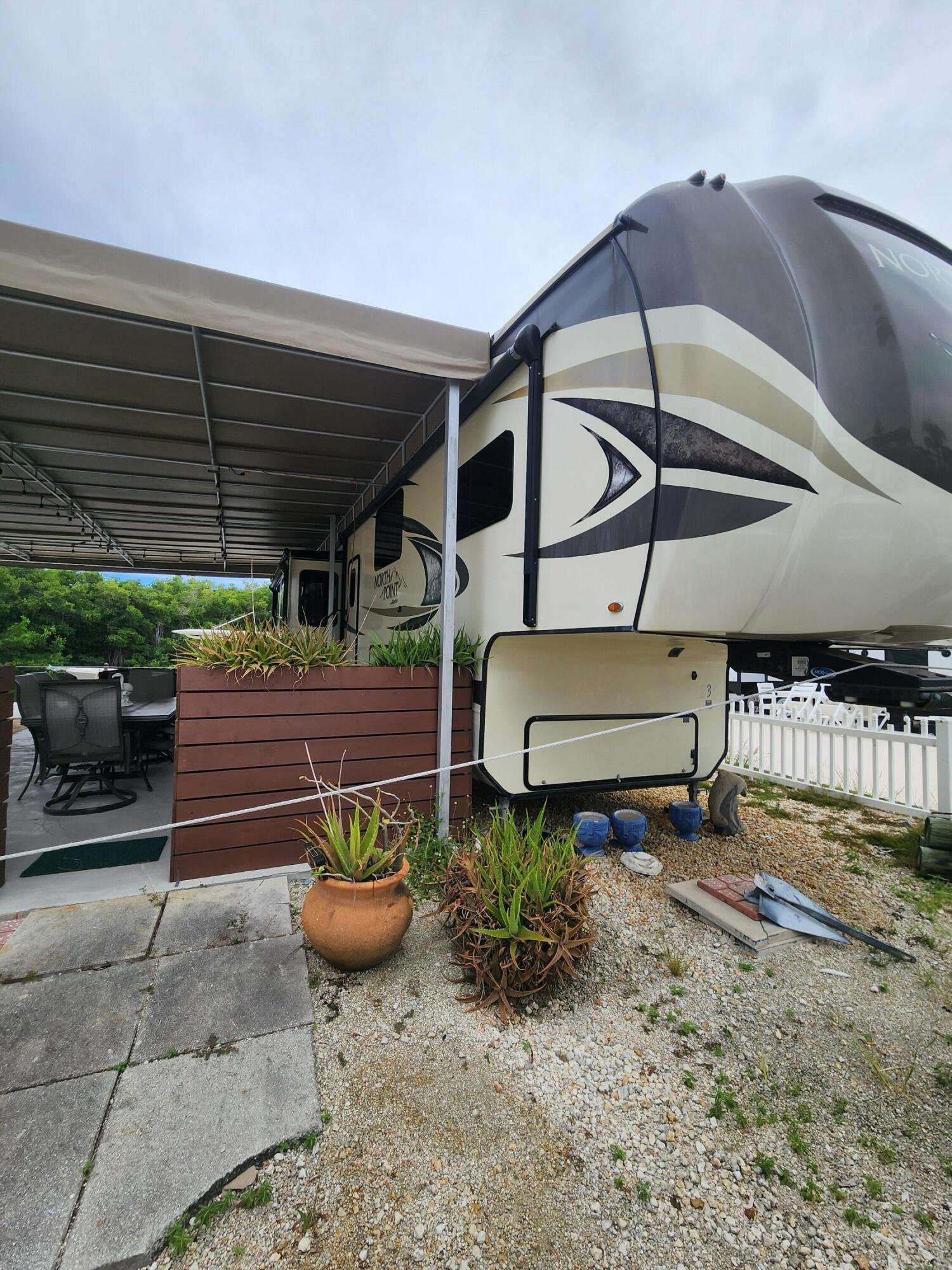 325 Calusa Street, Unit 234 Key Largo, FL 33037 - Photo 4 of 46 a view of a backyard with table and chairs