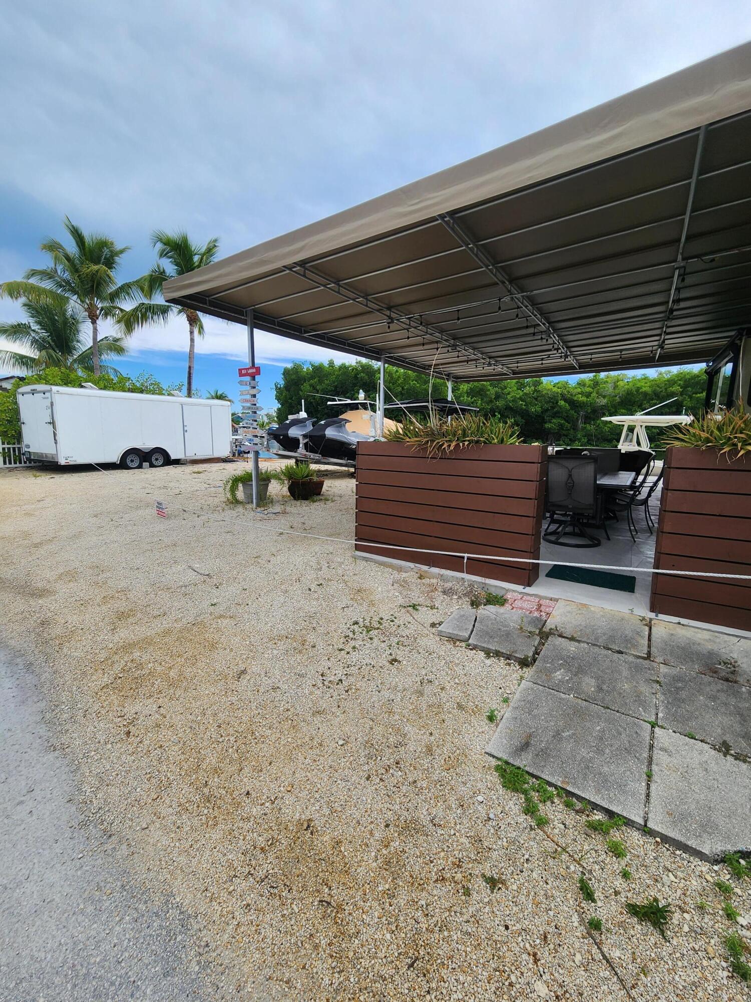 325 Calusa Street, Unit 234 Key Largo, FL 33037 - Photo 5 of 46 a view of patio with table and chairs under an umbrella