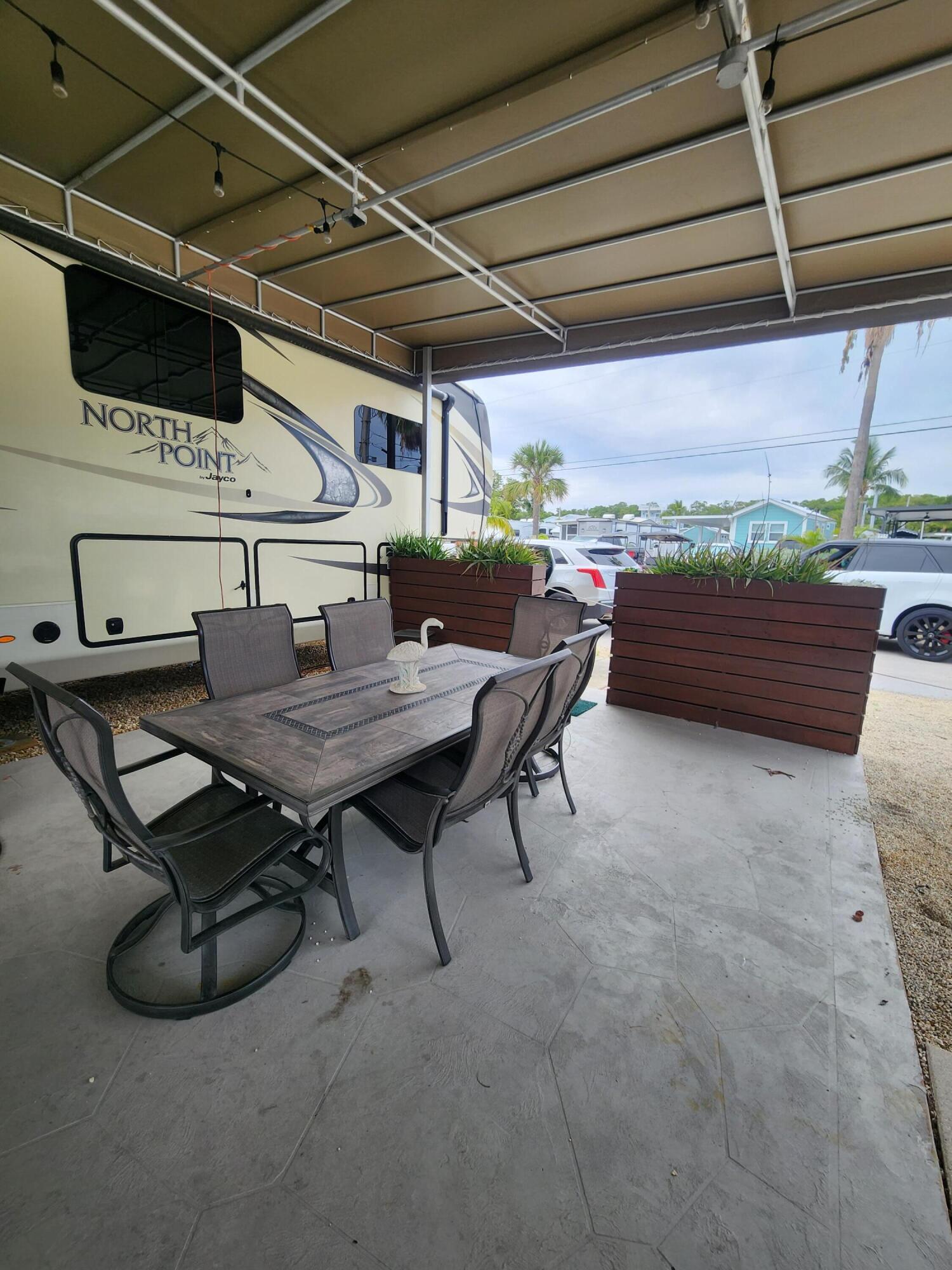 325 Calusa Street, Unit 234 Key Largo, FL 33037 - Photo 7 of 46 a roof deck with a table and chairs