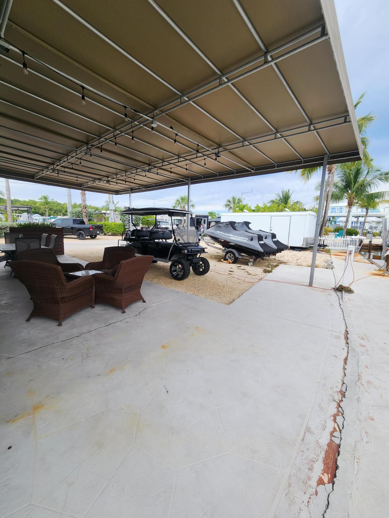 325 Calusa Street, Unit 234 Key Largo, FL 33037 - Photo 9 of 46 a view of patio with a table and chairs under an umbrella