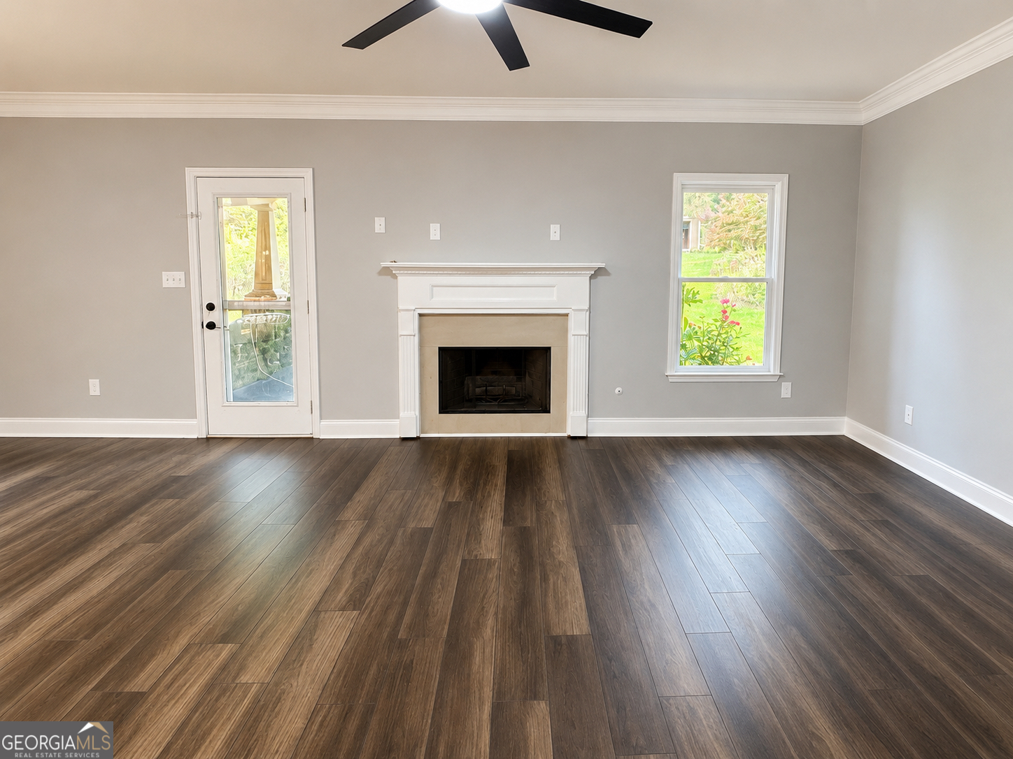 2614 Dolostone Way Dacula, GA 30019 - Photo 14 of 29 wooden floor fireplace and windows in an empty room