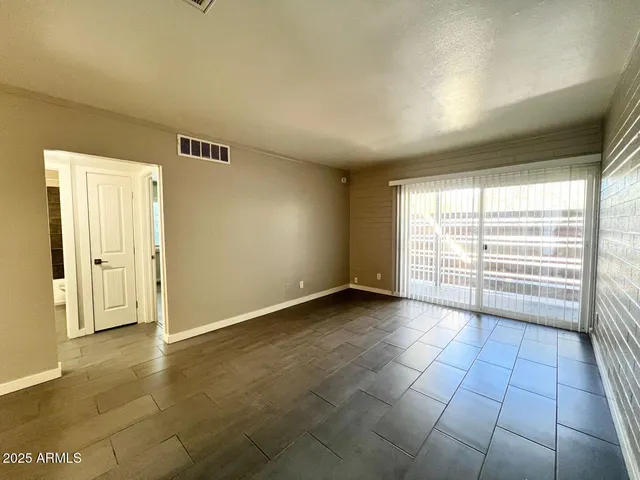 a view of an empty room with a window