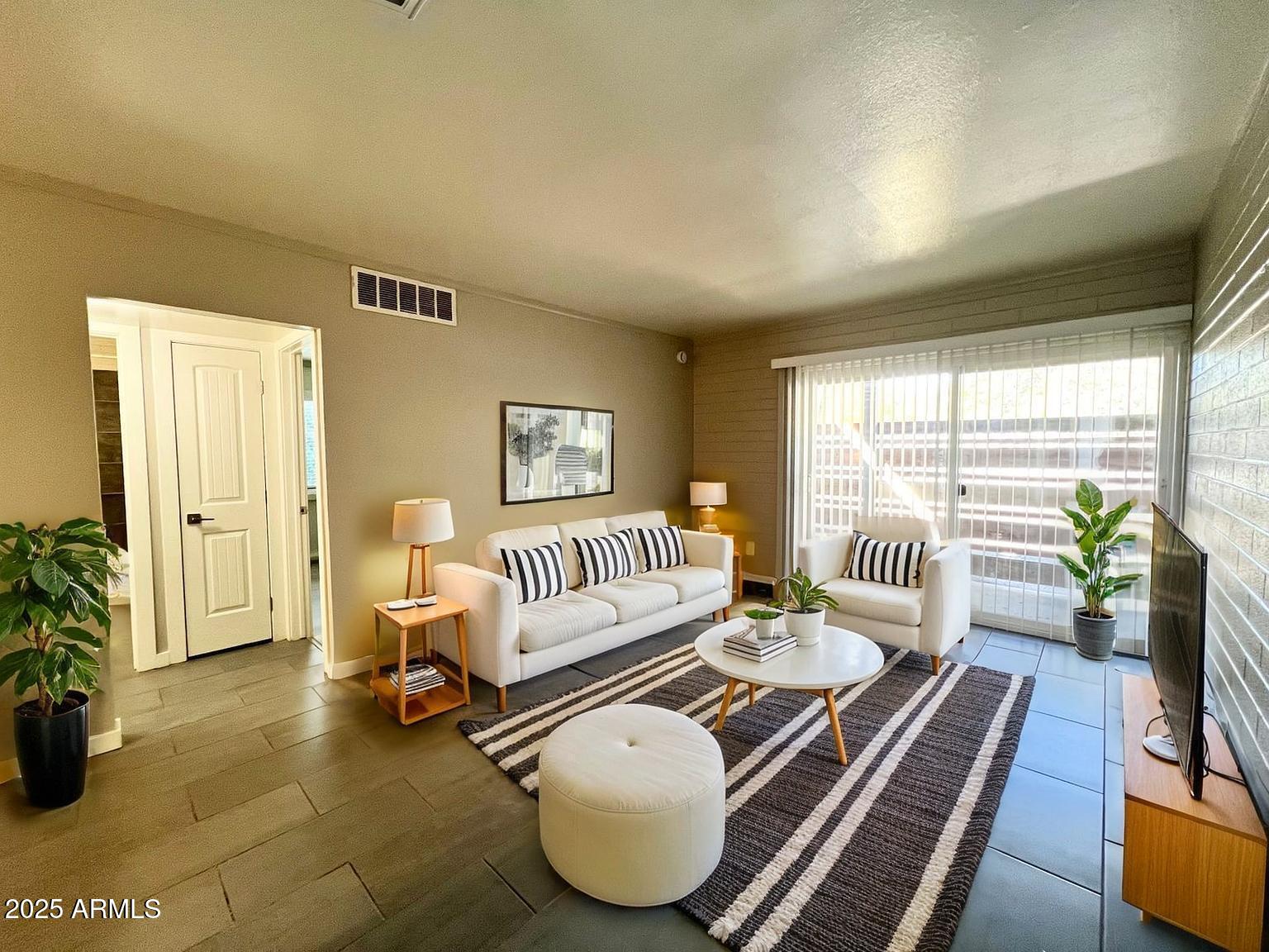 626 South Wilson Street Tempe, AZ 85281 - Photo 4 of 23 a living room with furniture and a floor to ceiling window