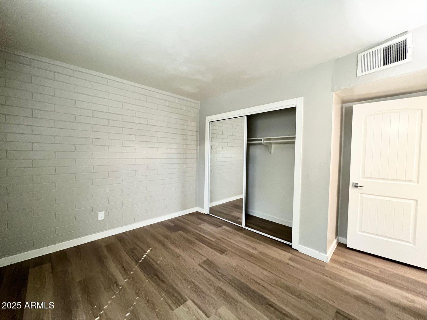 626 South Wilson Street Tempe, AZ 85281 - Photo 7 of 23 a view of an empty room with wooden floor