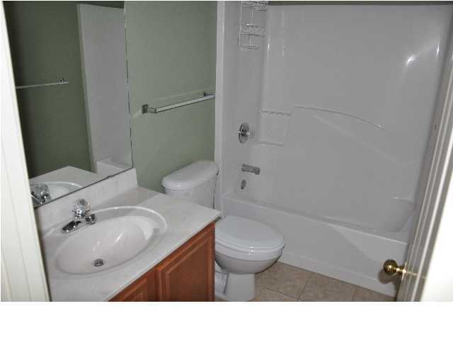 201 Beacon Way Santa Rosa Beach, FL 32459 - Photo 3 of 13 a bathroom with a sink toilet a mirror and shower