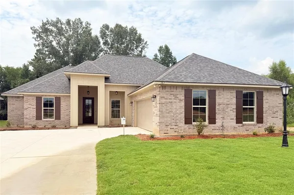 a front view of house with a garden and patio