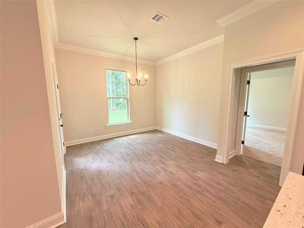 187 Lessie Drive Stonewall, LA 71078 - Photo 11 of 29 an empty room with wooden floor and windows