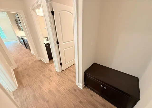 an empty room with wooden floor and white walls