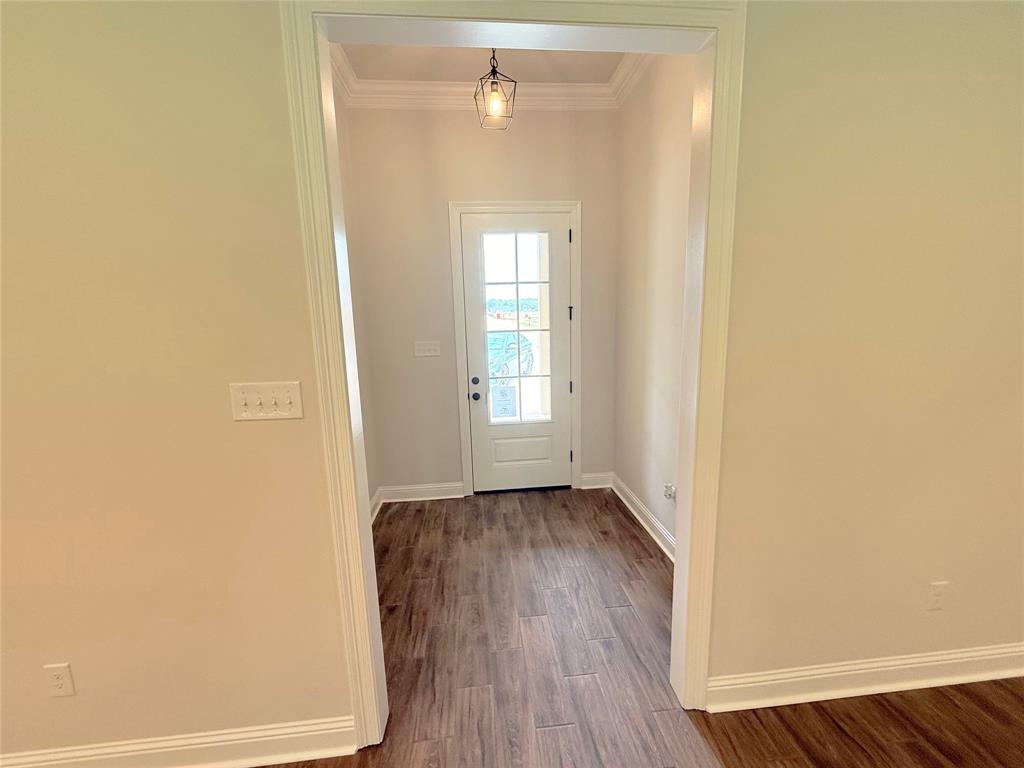 187 Lessie Drive Stonewall, LA 71078 - Photo 2 of 29 an empty room with wooden floor and windows