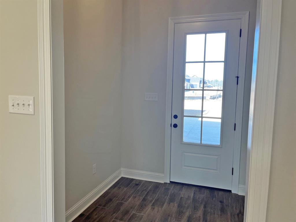 187 Lessie Drive Stonewall, LA 71078 - Photo 3 of 29 an empty room with wooden floor and windows
