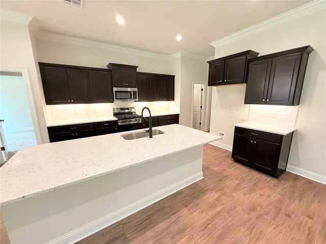 a spacious bedroom with a bed and a television