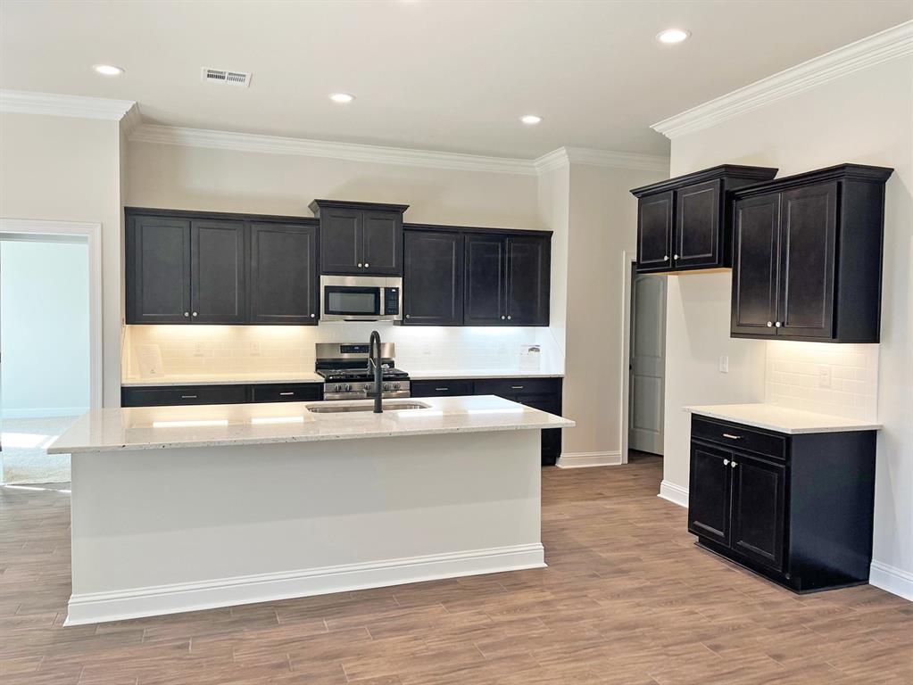 187 Lessie Drive Stonewall, LA 71078 - Photo 6 of 29 a view of kitchen with stainless steel appliances granite countertop wooden cabinets and a refrigerator