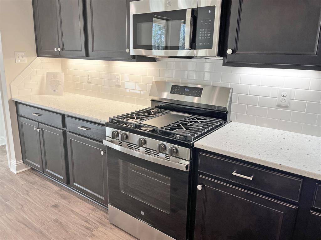 187 Lessie Drive Stonewall, LA 71078 - Photo 8 of 29 a kitchen with granite countertop cabinets and steel stainless steel appliances