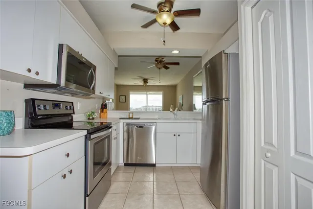 a kitchen with a sink stainless steel appliances and cabinets