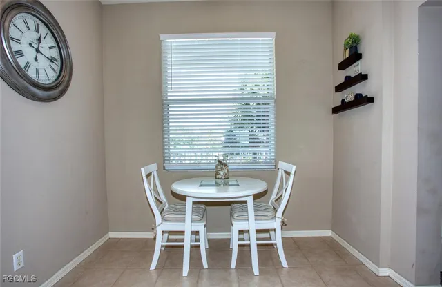 a dining room with furniture and window