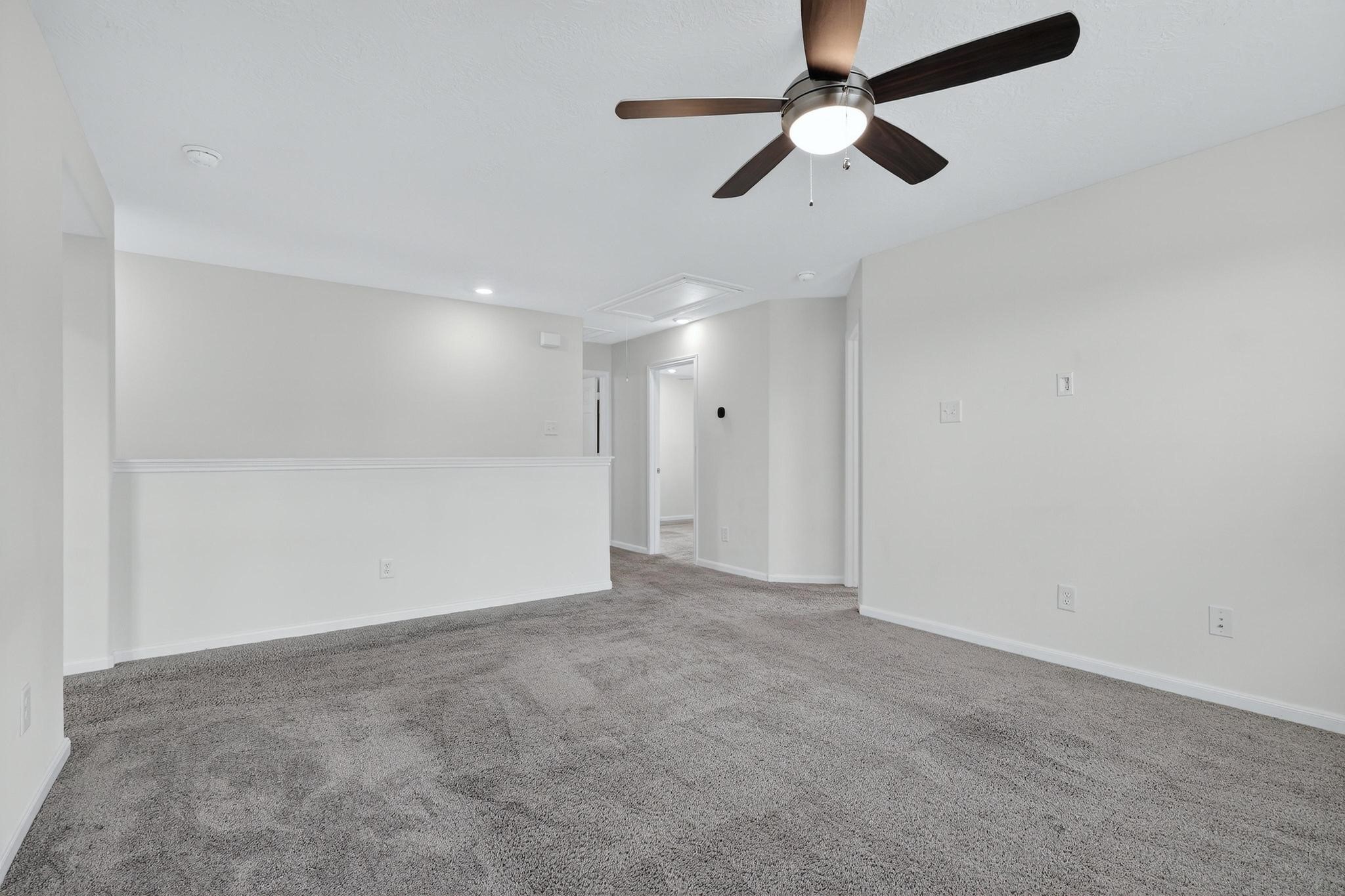 3322 Nila Creek Dr Spring Spring, TX 77373 - Photo 16 of 36 Alternate view of the spacious upstairs living area with open sightlines and ceiling fan for comfort.