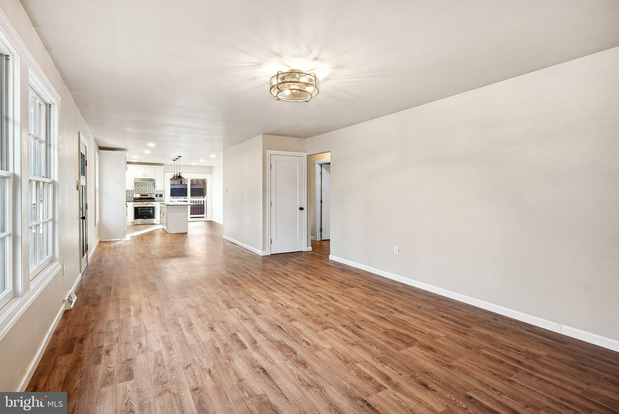 847 Whitehall Road Newfield, NJ 08344 - Photo 10 of 19 a view of a livingroom with wooden floor and a kitchen space